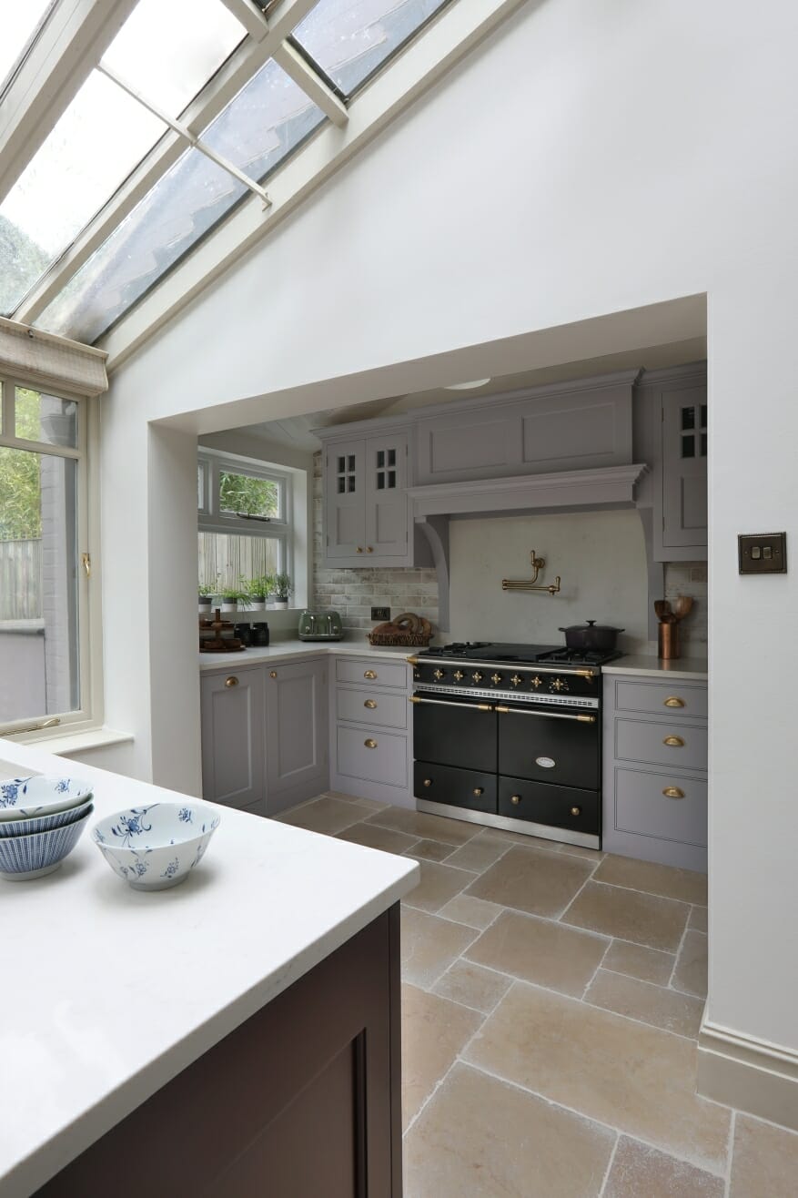 Light wood kitchen with glass-front cabinets.