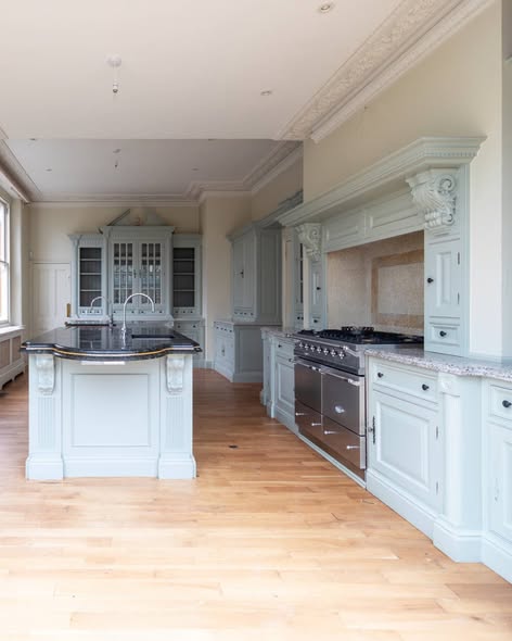 Natural wood kitchen with black range and island.