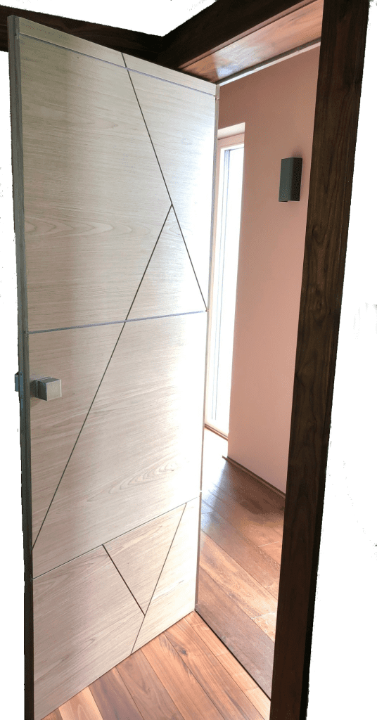 Open veneered door viewed from a hallway with its dark edge visible.