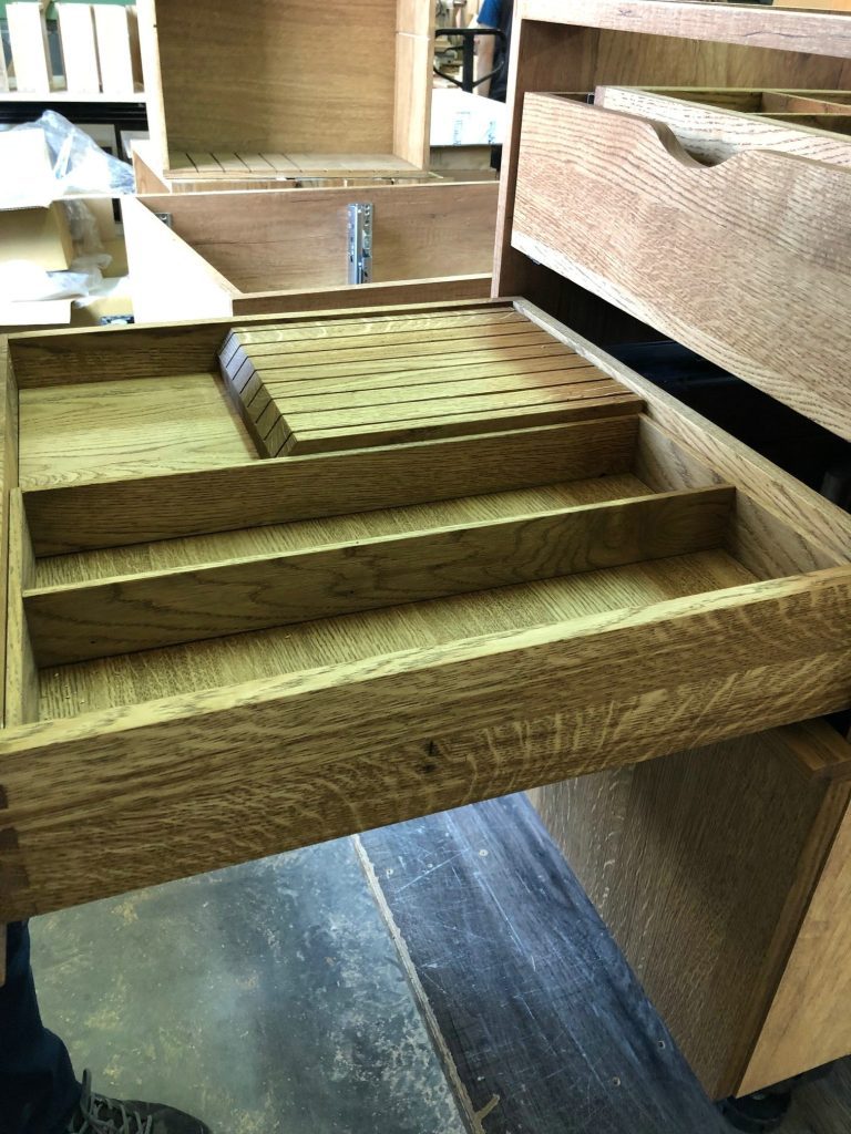 Wood drawer insert with repeated slots.