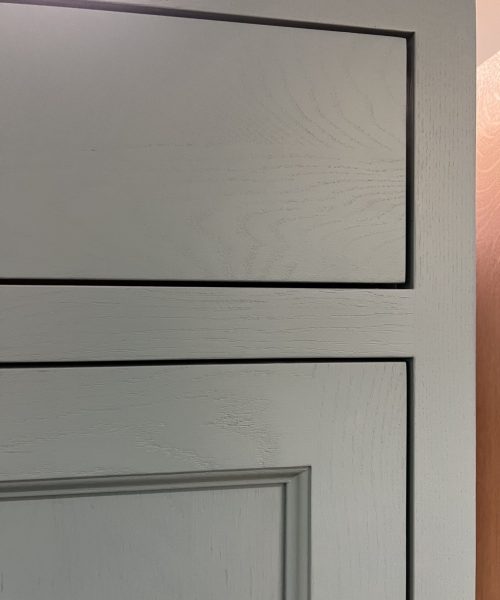 Pale gray inset cabinet panel.
