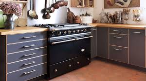 Pale green kitchen with patterned backsplash.