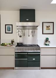 Pale kitchen with green island and glass doors.