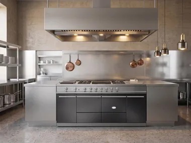 Pale kitchen with patterned backsplash and black range.