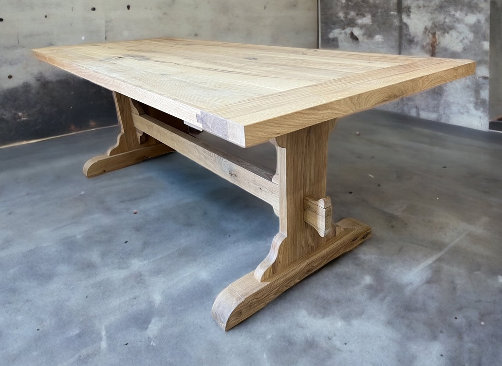 Rectangular pale tabletop with broad turned end supports and central stretcher.