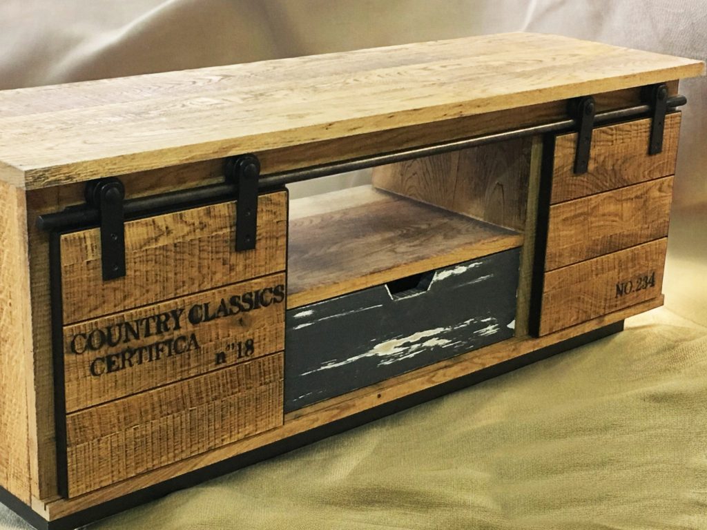 Low rustic media cabinet with sliding doors, drawers and visible wood grain.