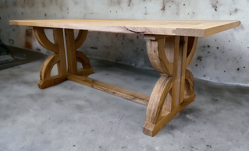 Table with distinctive symmetrical scroll-shaped wooden supports.