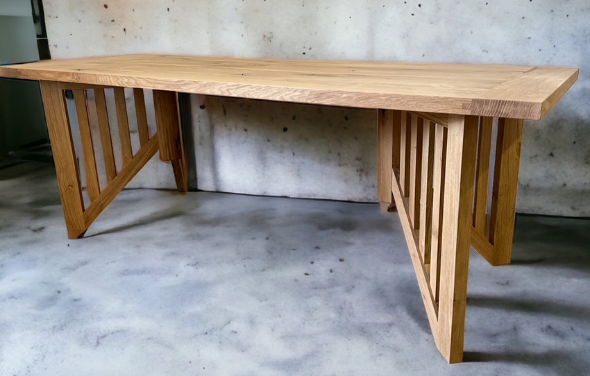 Light tabletop on a highly slatted pair of wood trestle supports.