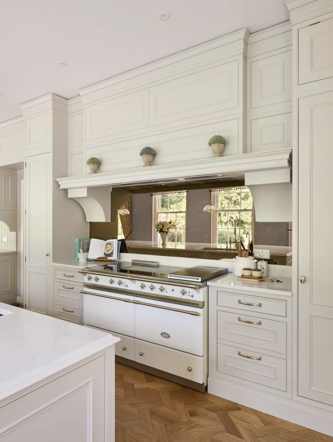White kitchen with framed opening and range; detail src-0262