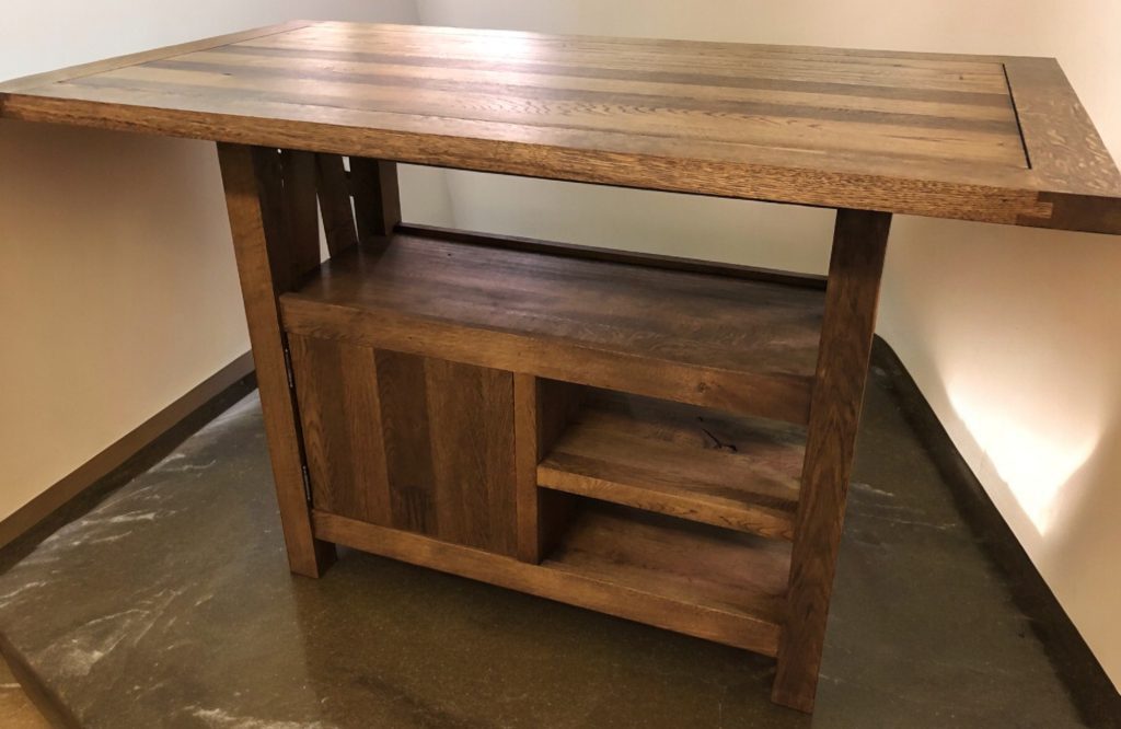 Solid wood console or island table with open lower shelf and dark metal legs.