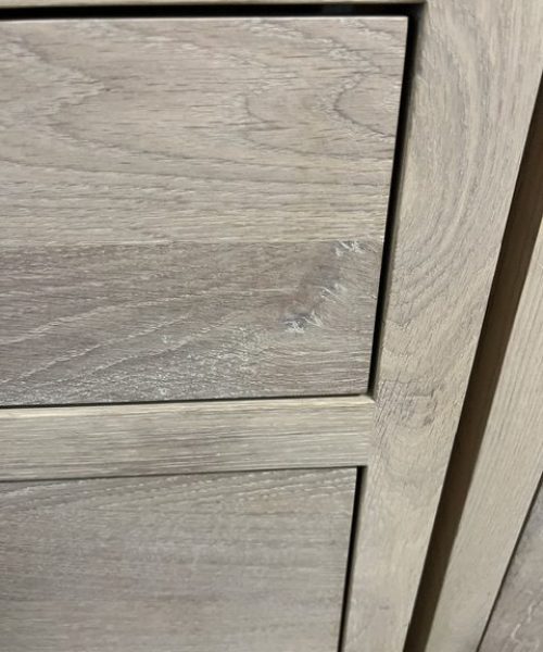 Stacked pale wood-grain cabinet fronts.