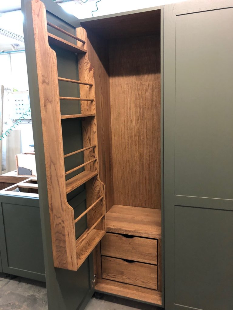 Wood drawer with vertical divider pegs.