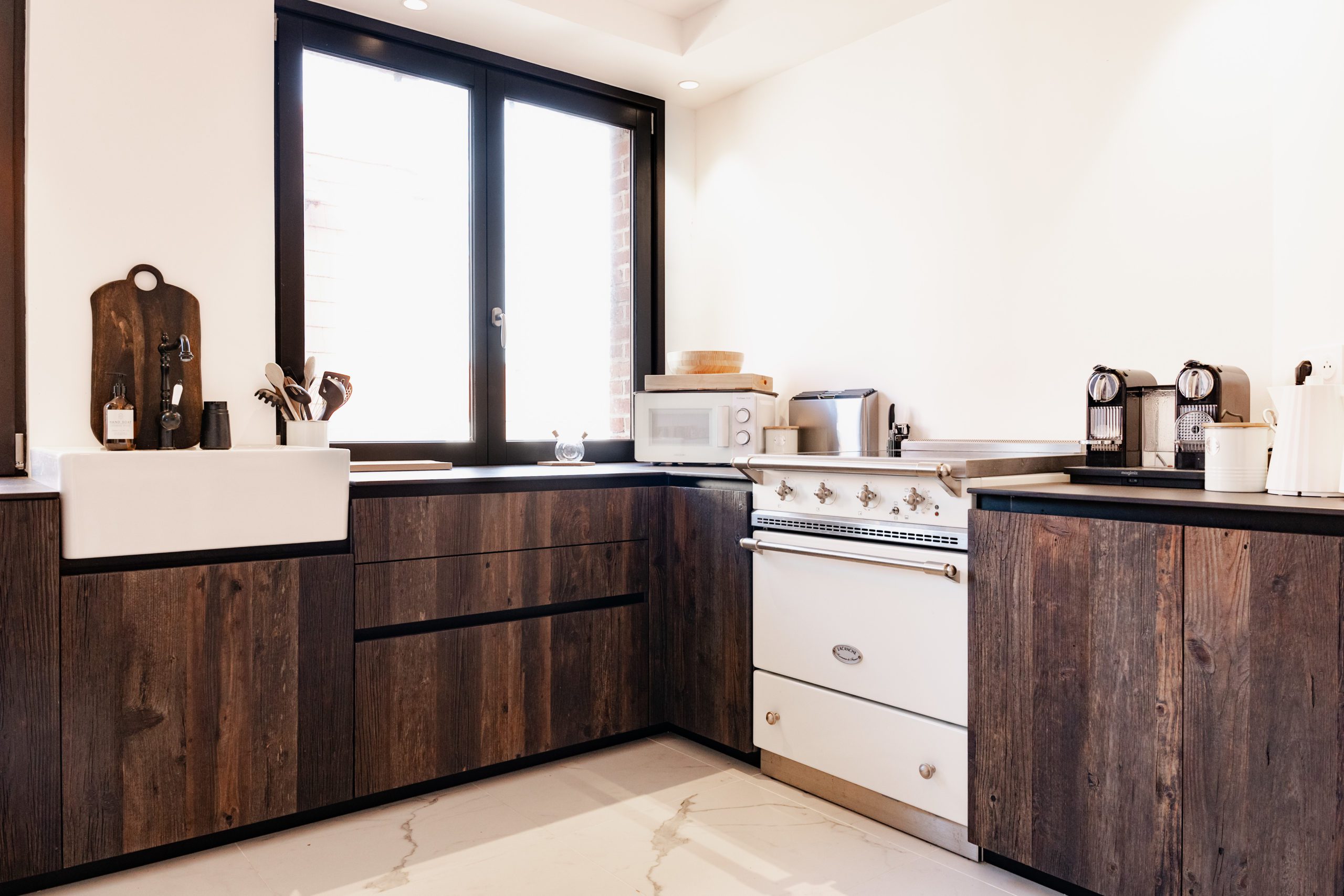 Warm kitchen with wood ceiling and island.