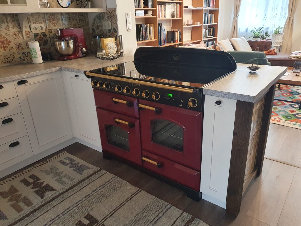 Compact kitchen with dark red range; detail src-0267