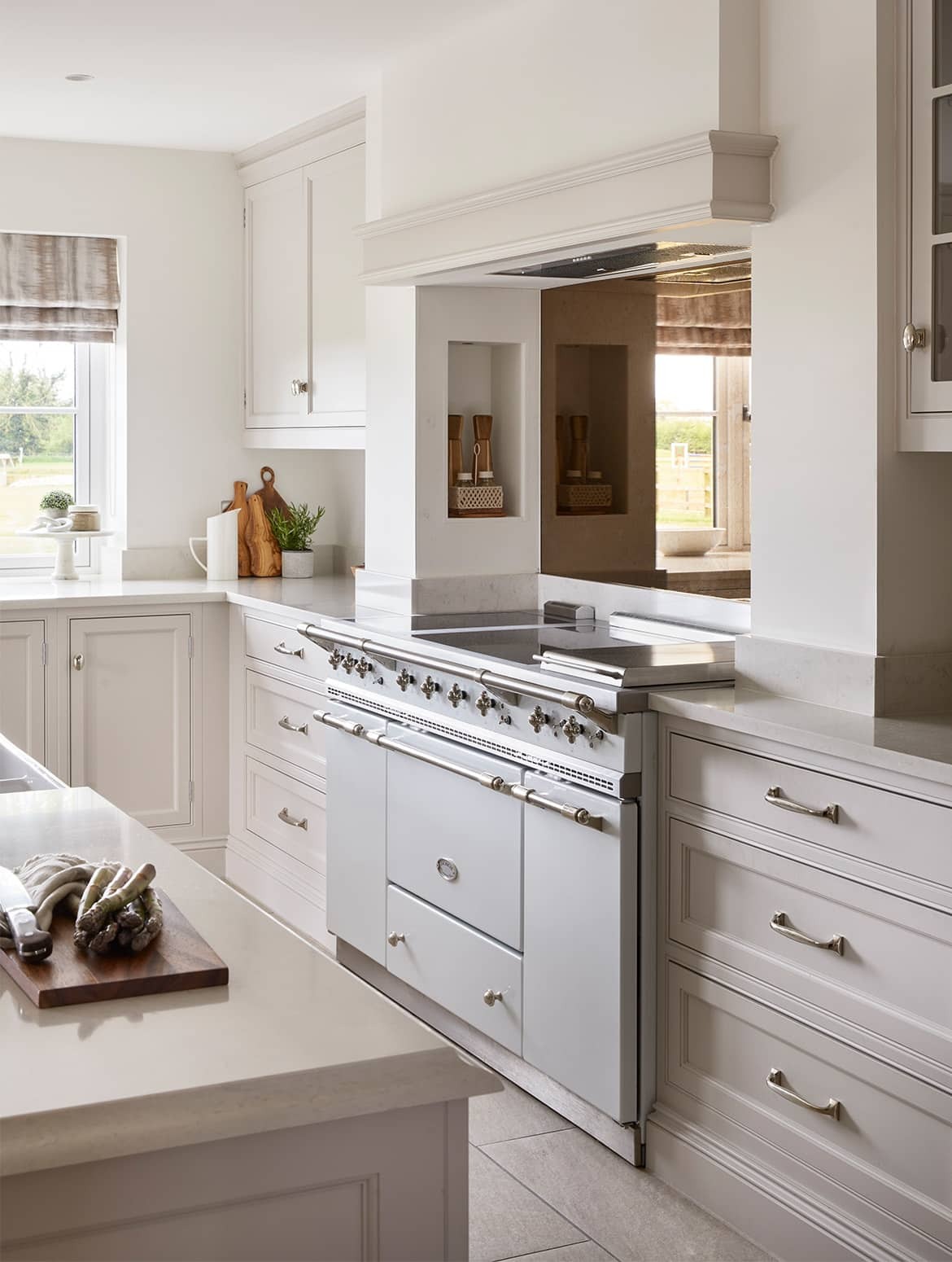 White-gray kitchen with island and beams.