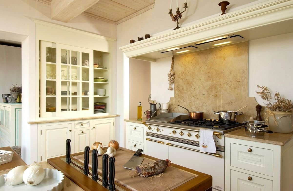 White kitchen with black island and stools.