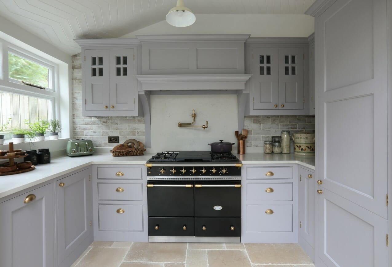 White kitchen with blue-gray island.