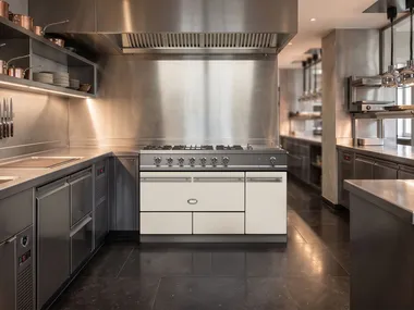 White kitchen with centered dark range.