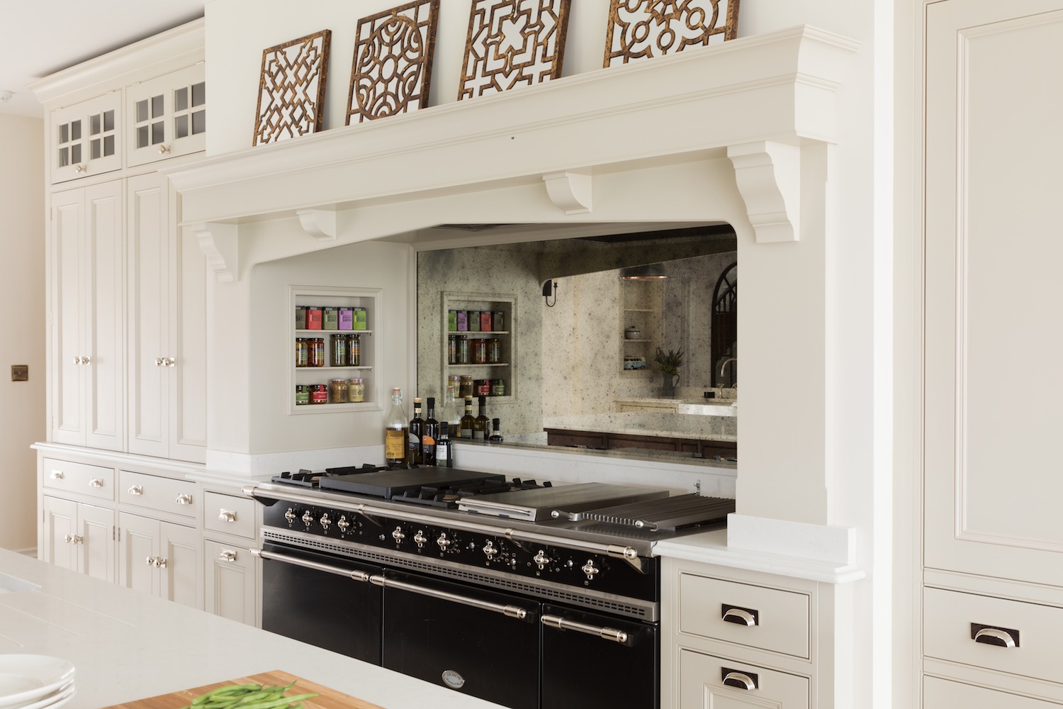 White kitchen with dark central range.