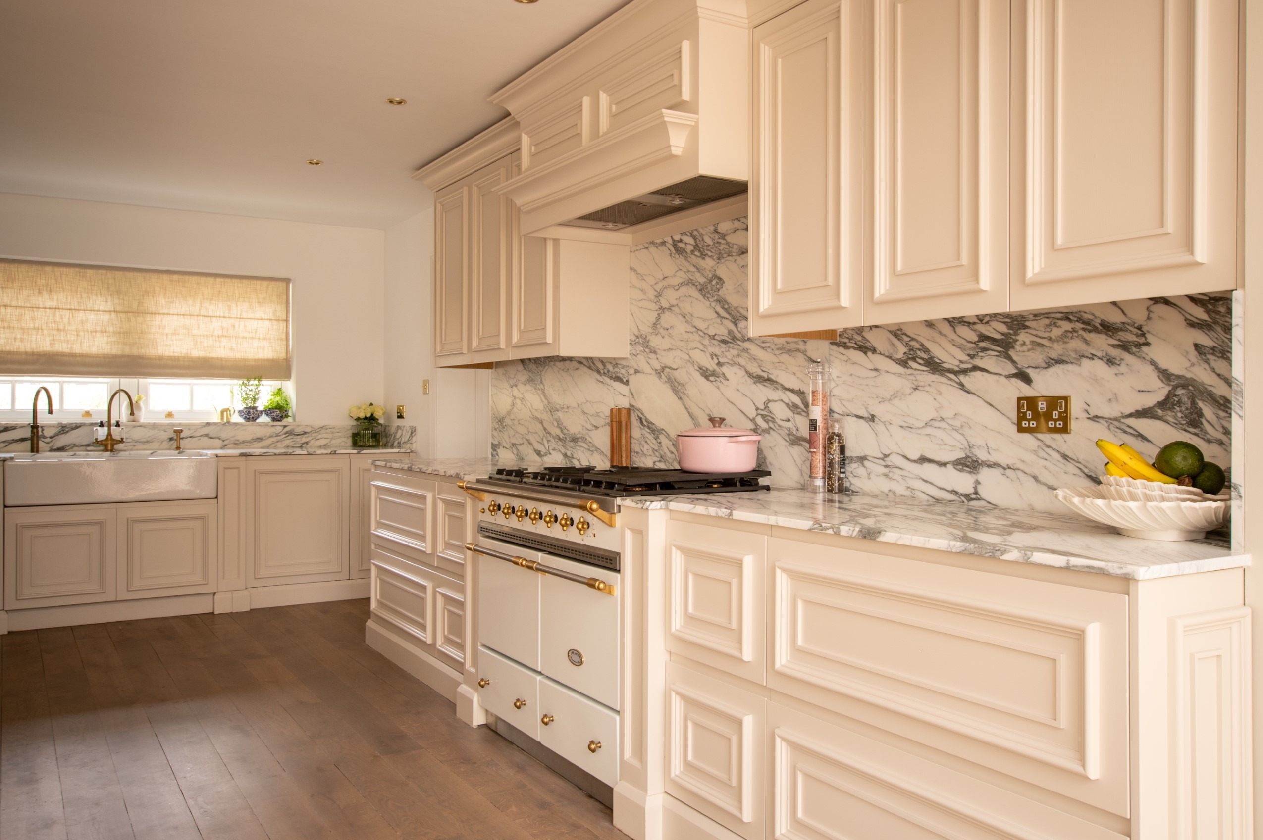White kitchen with dark range and black-framed window.