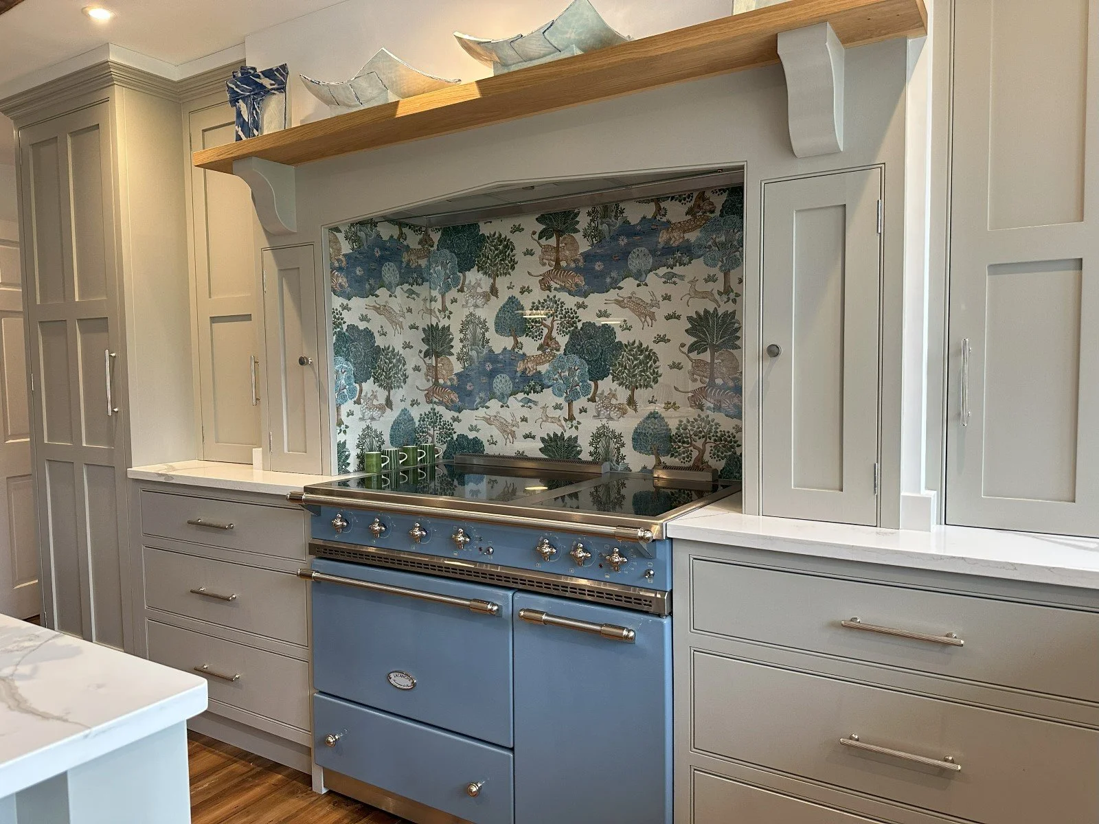 White kitchen with dark range and side window.