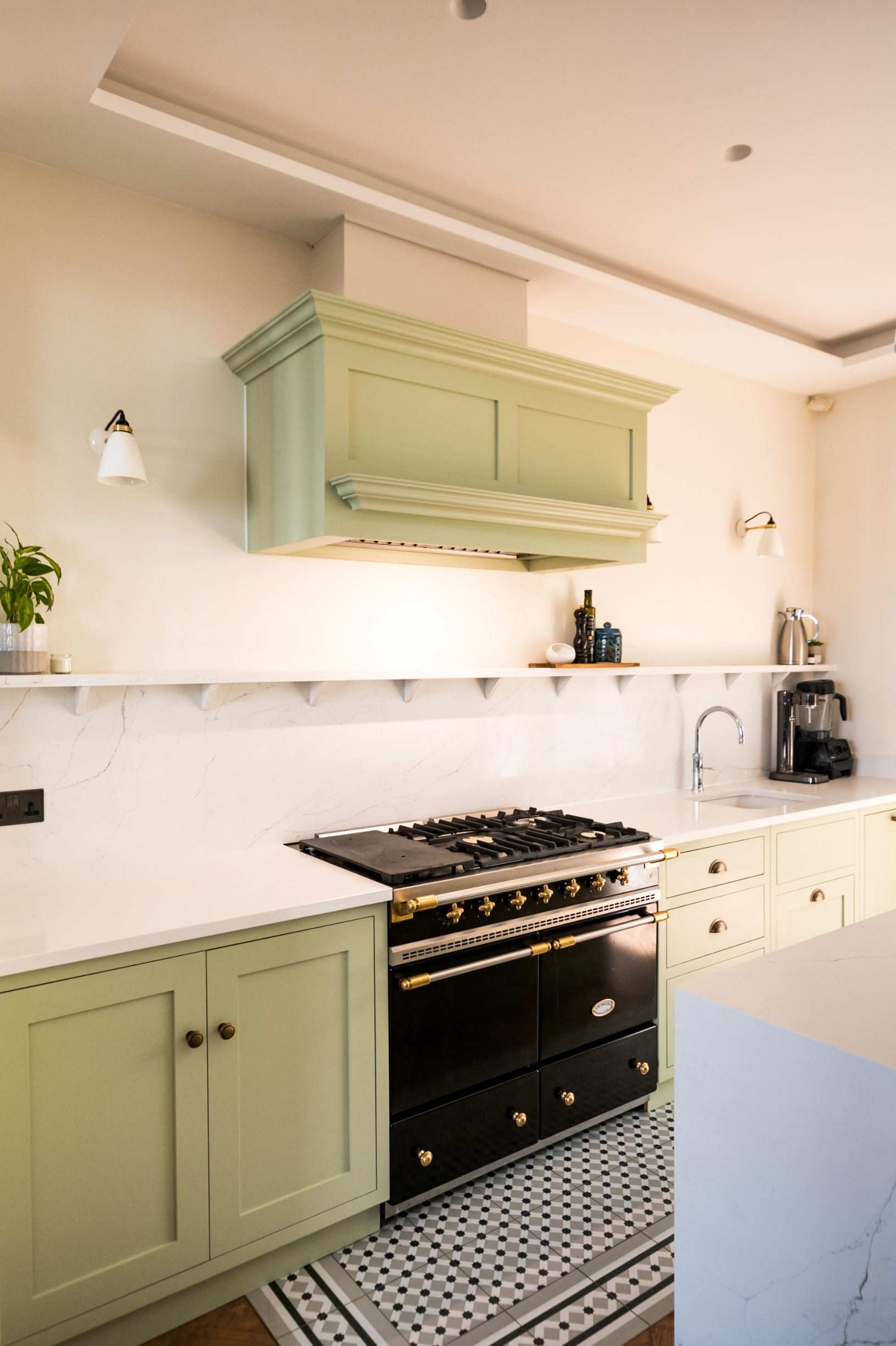 White kitchen with dark range and stone backsplash.