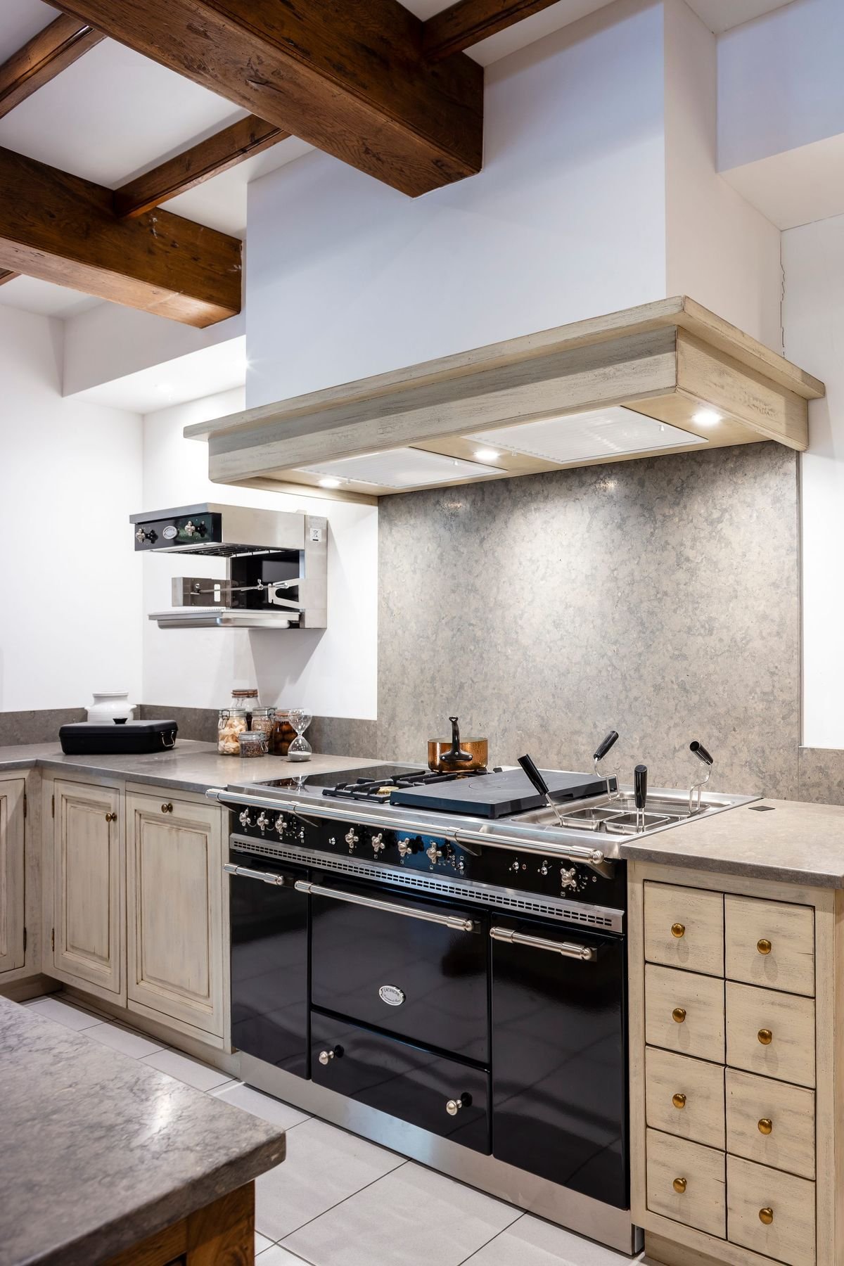 White kitchen with dark red island.