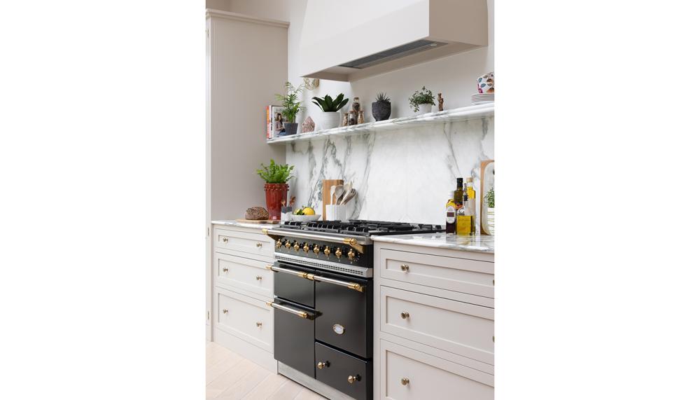White kitchen with framed hood and island.