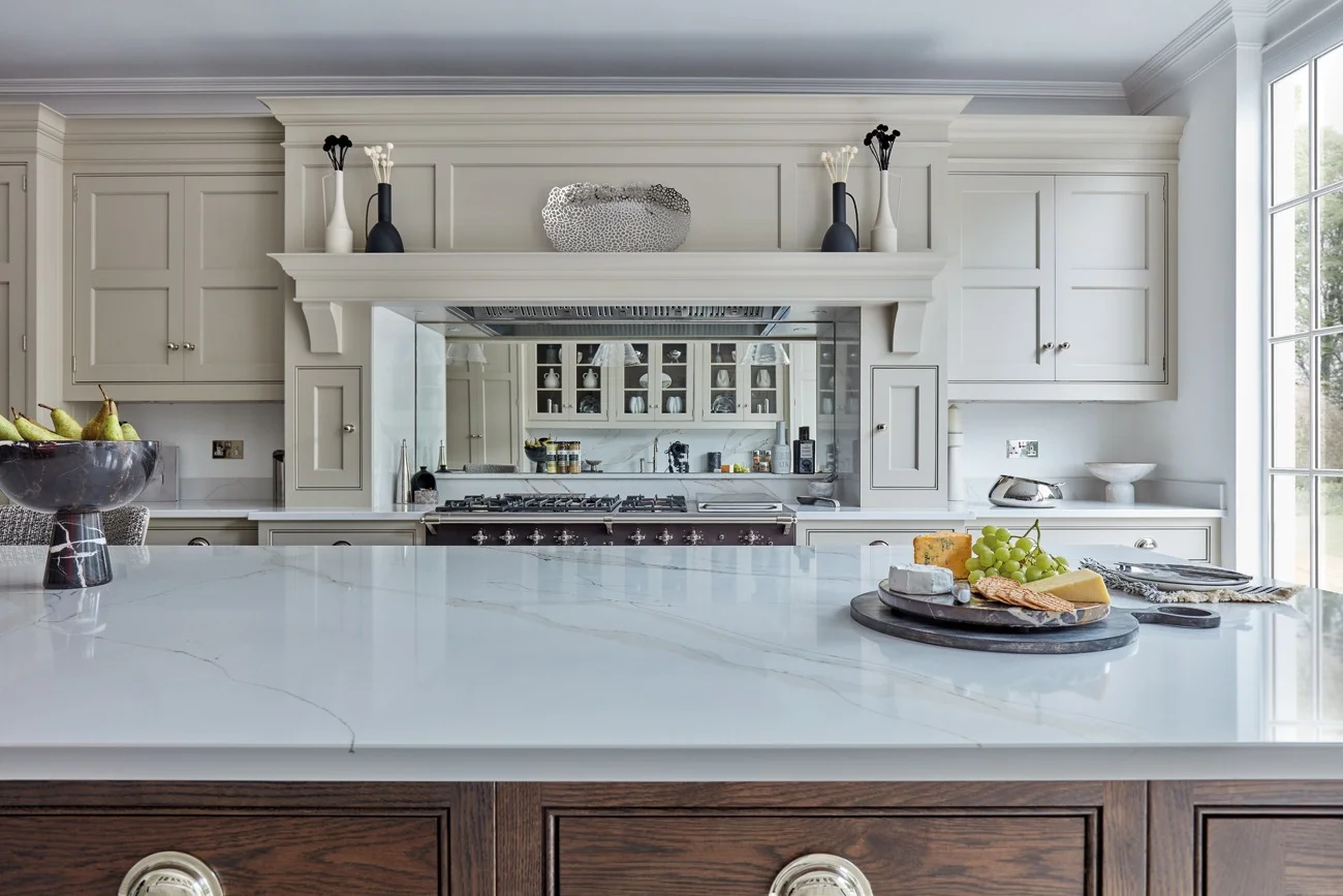 White kitchen with framed opening and range.