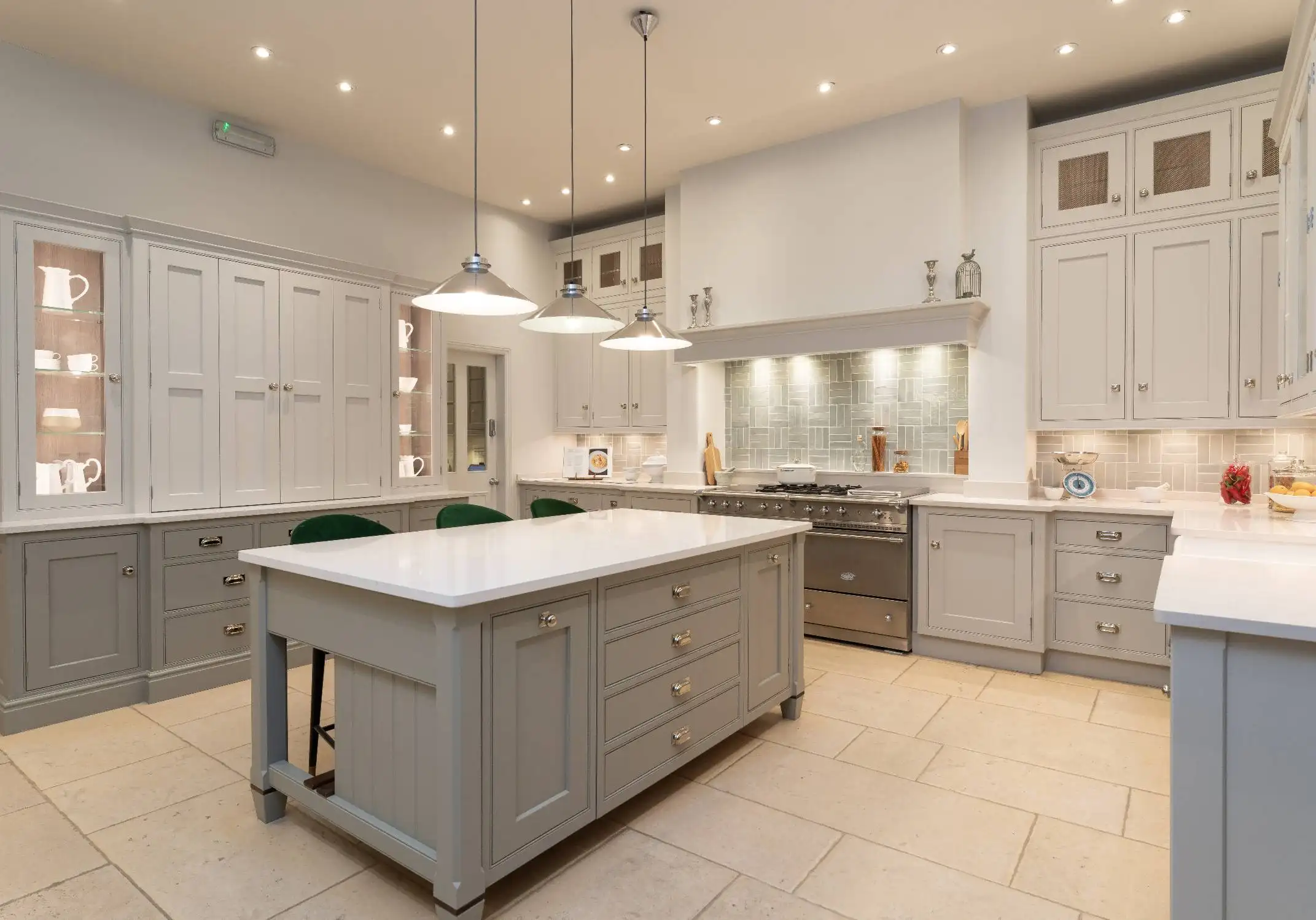 White kitchen with glass-front cabinets and range.