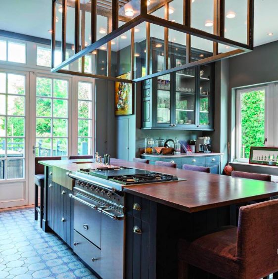 White kitchen with long island and range.