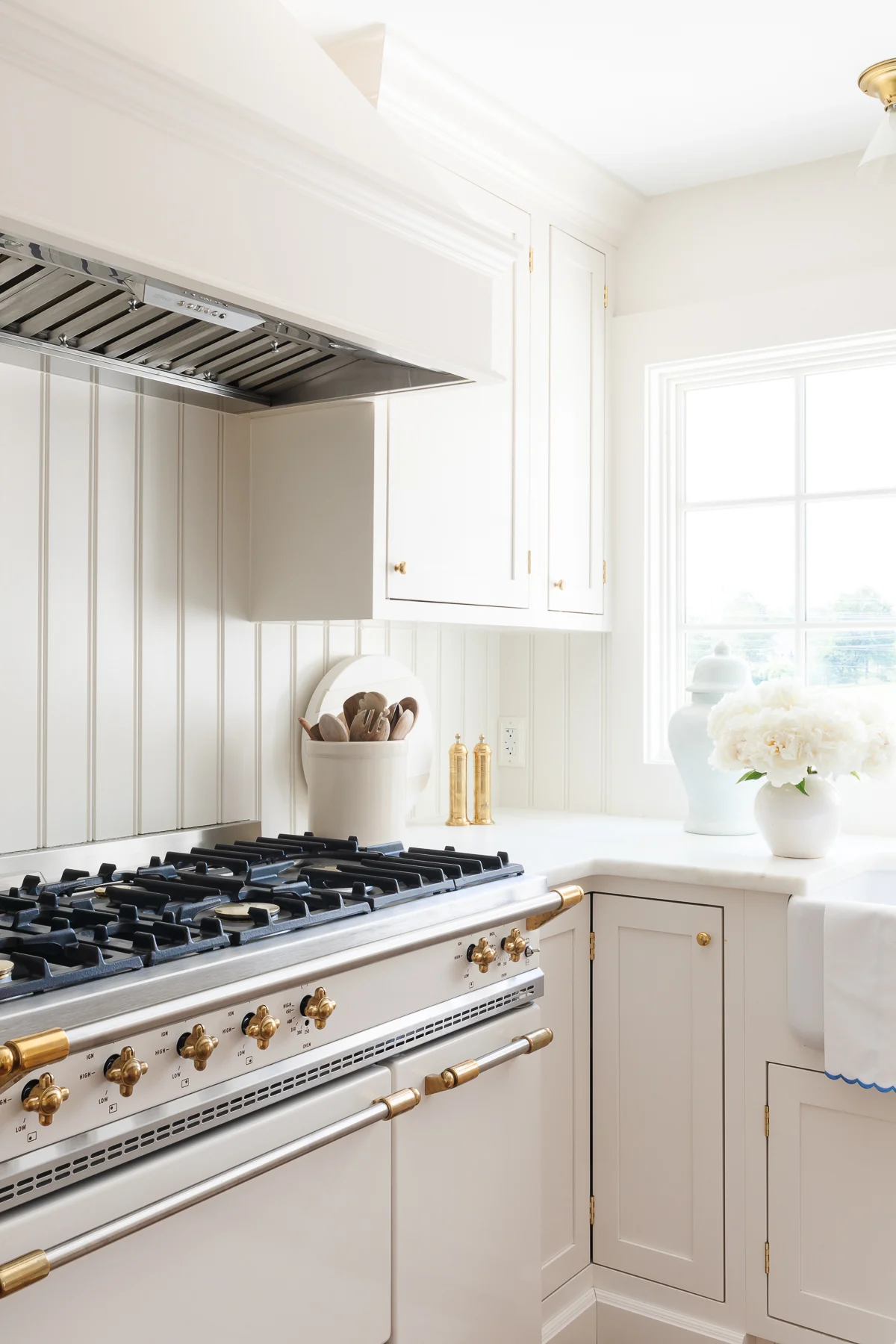 White vertical kitchen with black range.