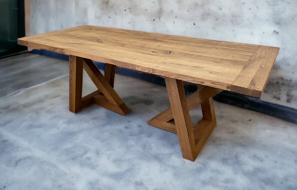 Wide wood tabletop on chunky triangular end supports.