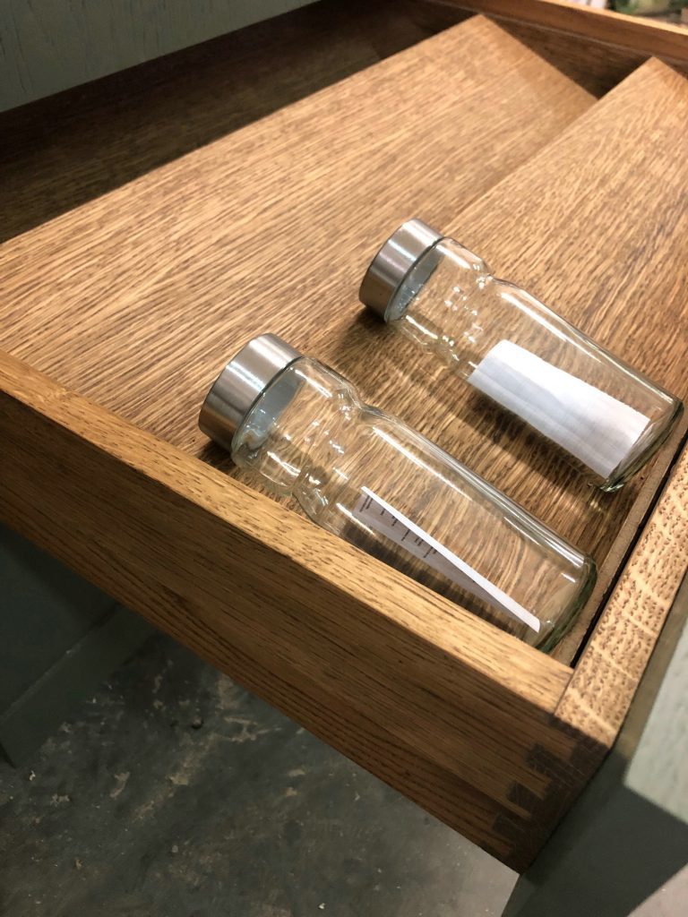 Wood drawer organizer with separated compartments.