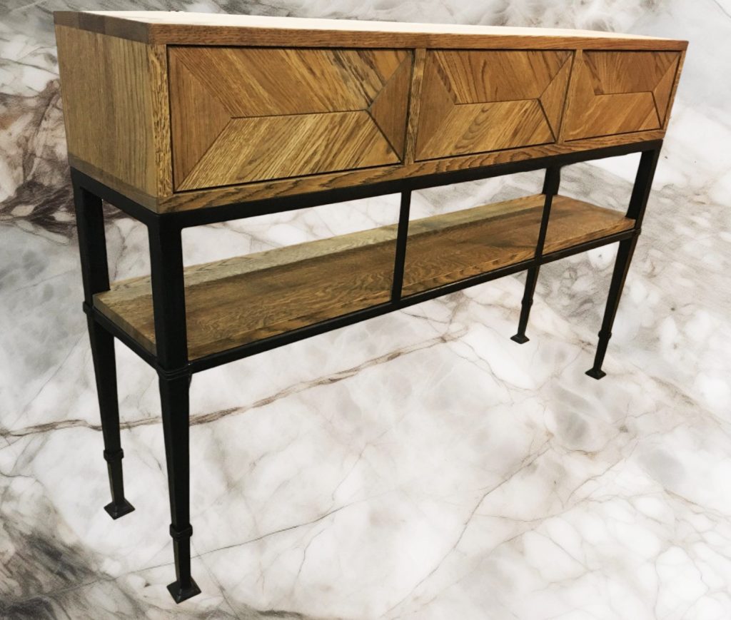 Narrow wood-and-metal console table with patterned top and shelf.