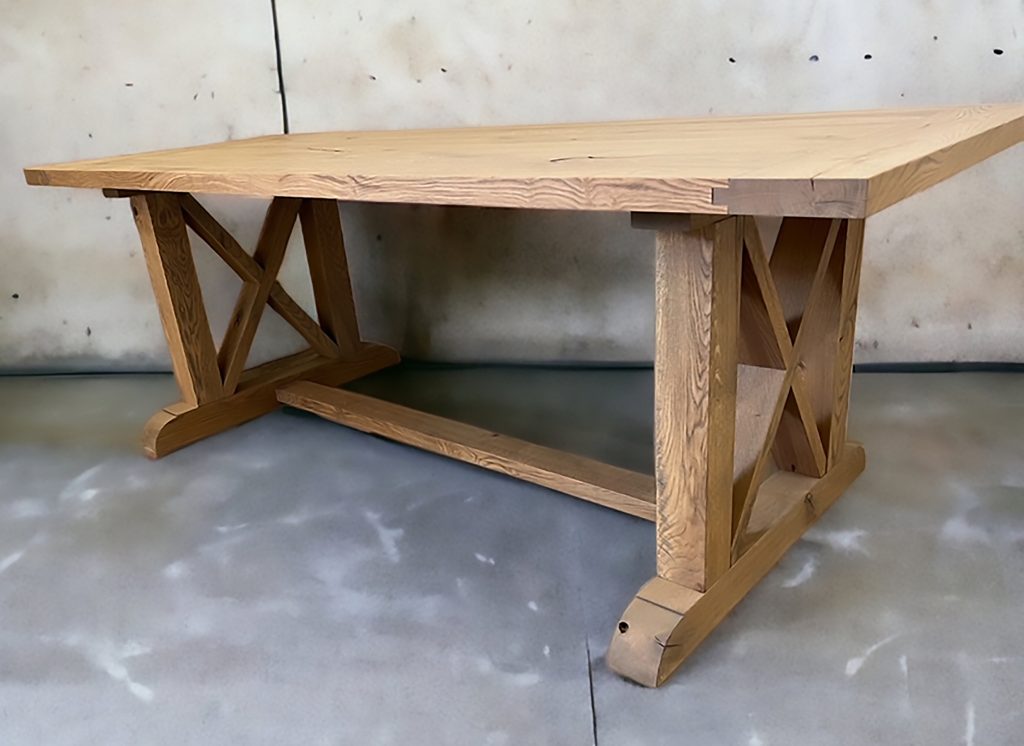 Wood table with crossed supports.